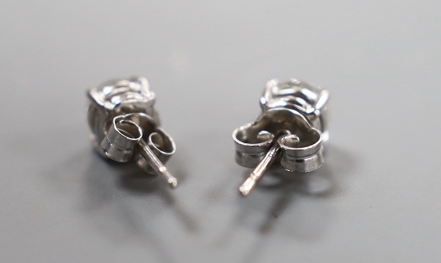 A pair of modern 750 white metal and solitaire diamond set ear studs